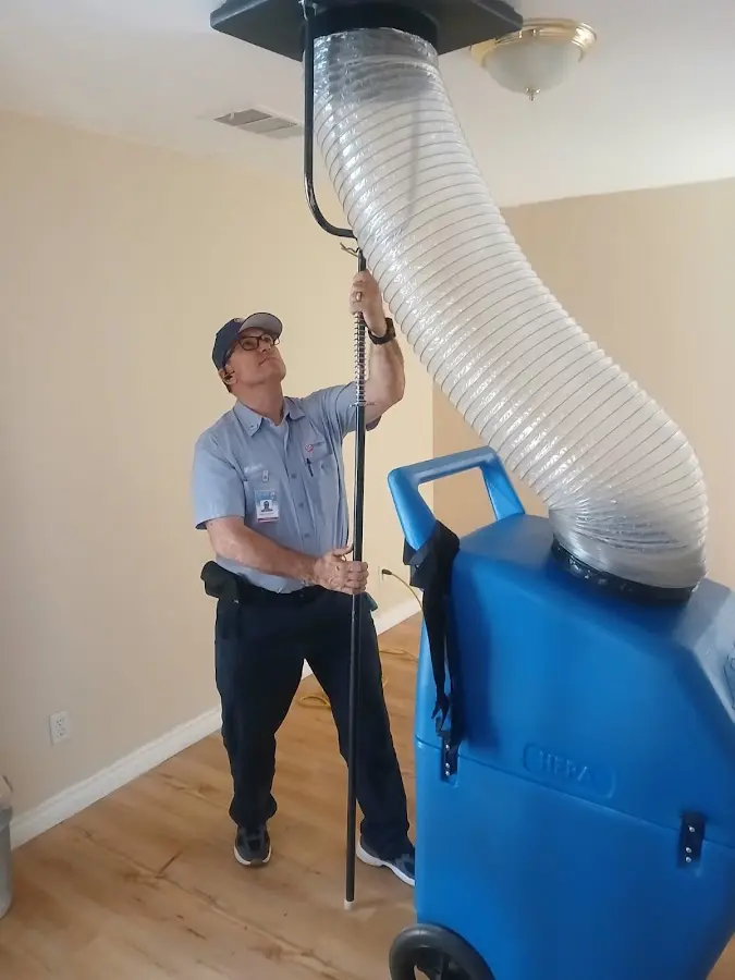 Furnace Tune-Up technician using HEPA equipment in Ellisville